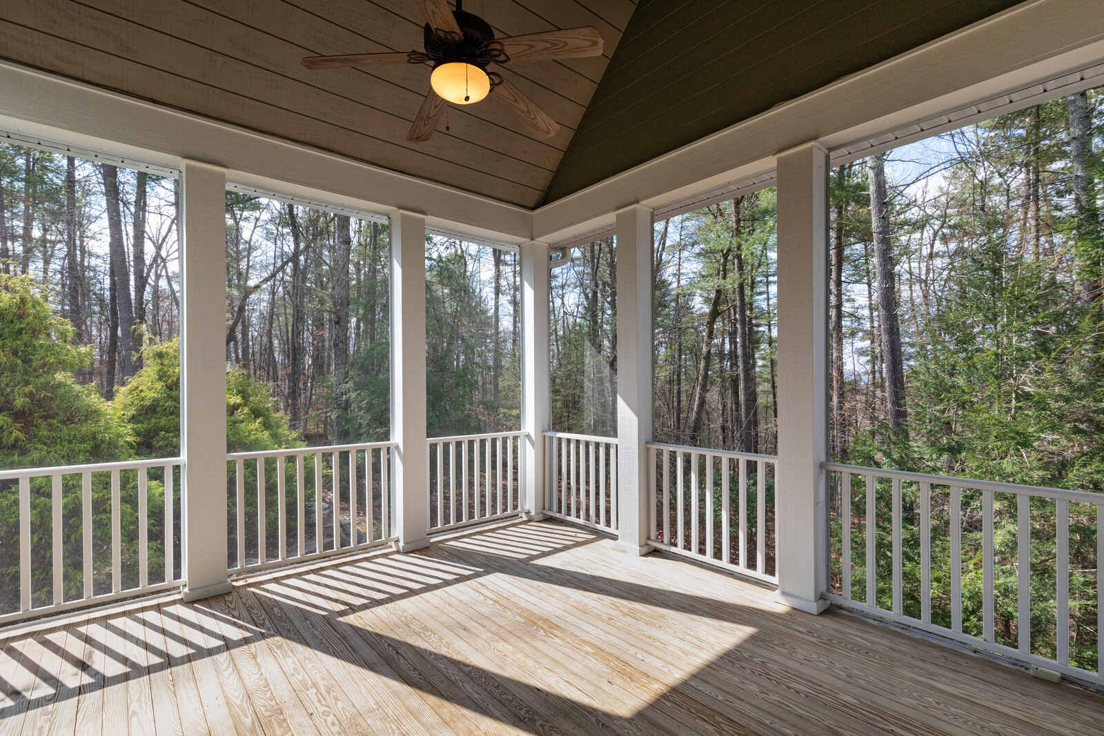 Custom-built home addition featuring a charming screened porch with scenic forest views in Durham, NC