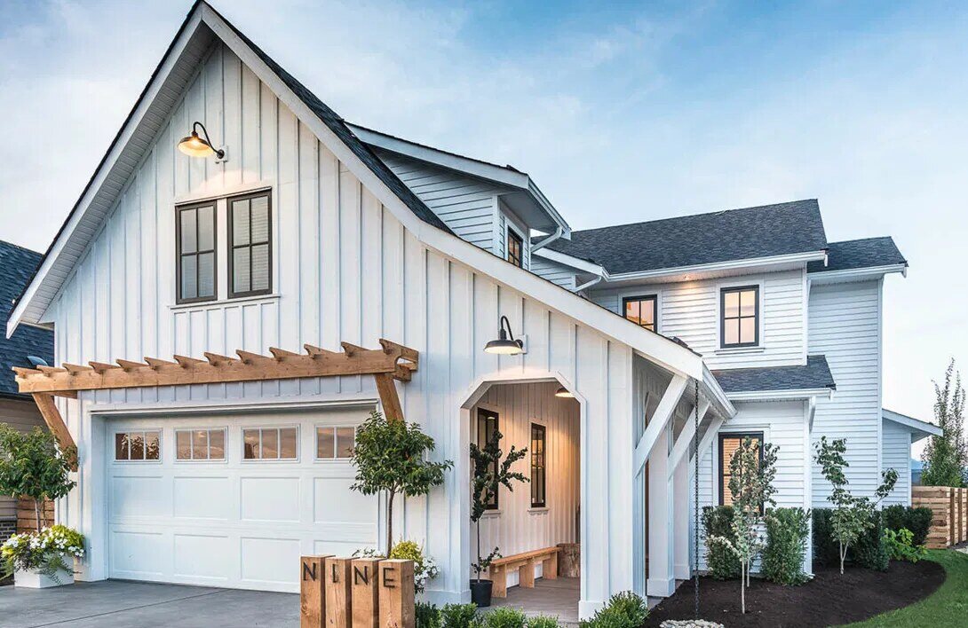 Charming white modern farmhouse with board and batten siding and a covered front porch, built by Triple Crown Contractors Charming white modern farmhouse with board and batten siding and a covered front porch, built by Triple Crown Contractors