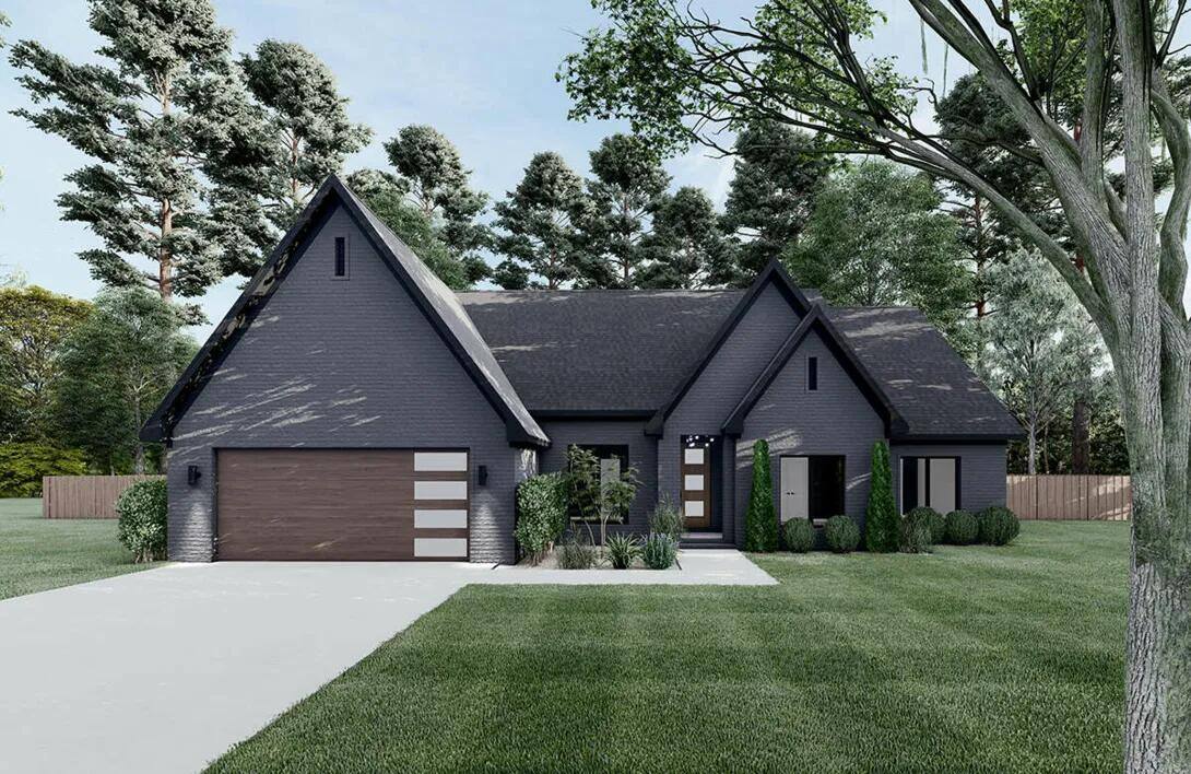 Luxury European-inspired custom home with a dark brick exterior and modern wood accents, built by Triple Crown Contractors
