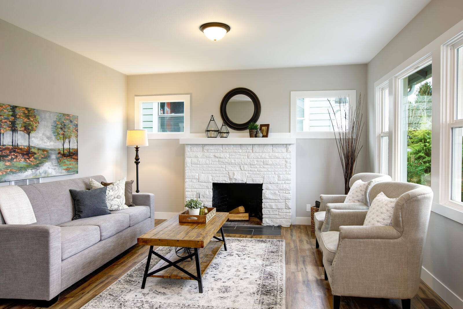 Cozy living room with a white brick fireplace in a whole home remodel by Triple Crown Contractors in Apex, NC Cozy living room with a white brick fireplace in a whole home remodel by Triple Crown Contractors in Apex, NC