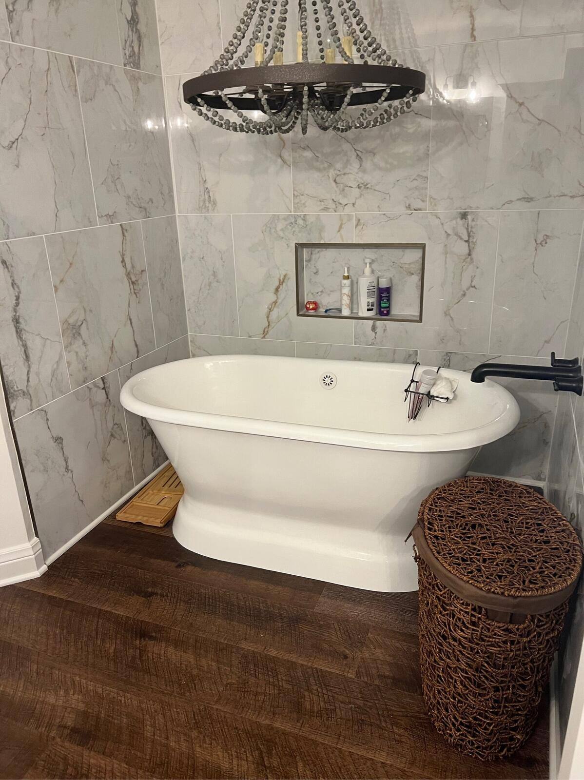 Luxury bathroom renovation by Triple Crown Contractors in Raleigh, NC, featuring a freestanding tub and marble-tiled walls