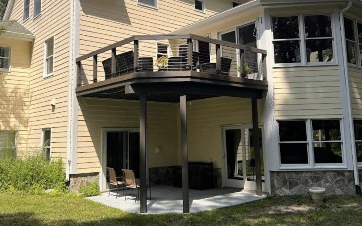 Elevated backyard deck and patio in West Chester by Triple Crown Home Builders, featuring a modern railing design, shaded seating area, and seamless integration with the homes architecture
