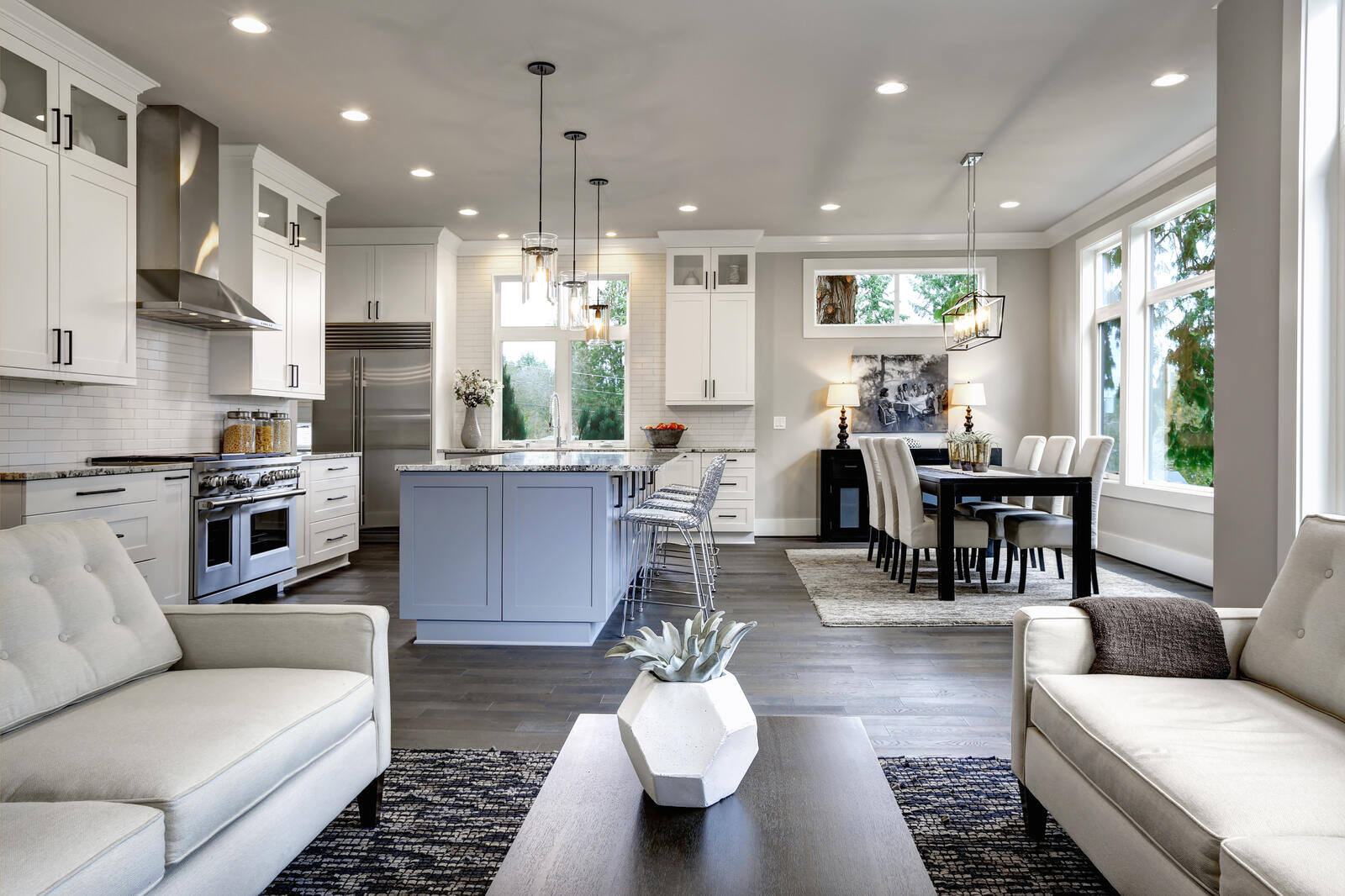 Elegant modern kitchen with white cabinetry, black accents, and pendant lighting in a renovated Durham, NC home